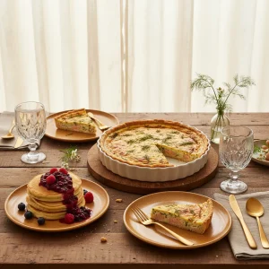 A beautifully styled table featuring Mother Day Breakfast Recipes including smoked salmon quiche and lemon ricotta pancakes.